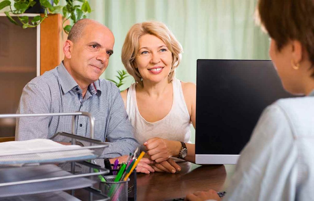 A couple talking to a mortgage loan originator