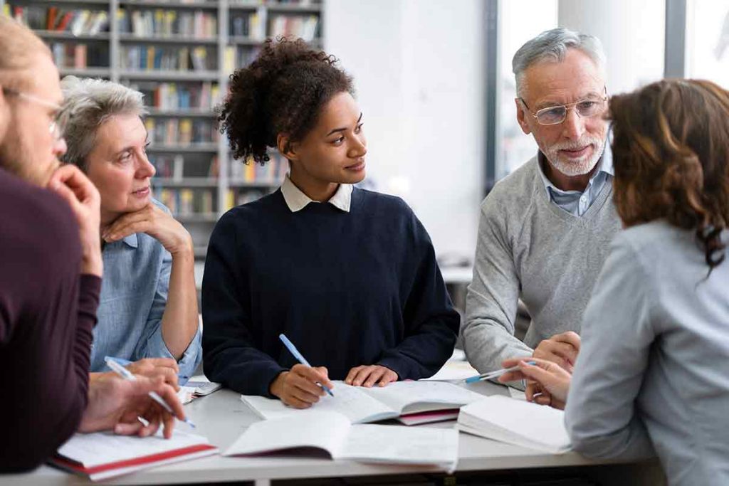 Students and teacher talking after Choosing the Best Pre-Licensing Course