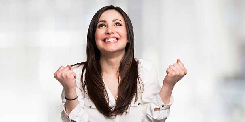 Woman celebrating after learning about real estate careers that don’t require selling homes