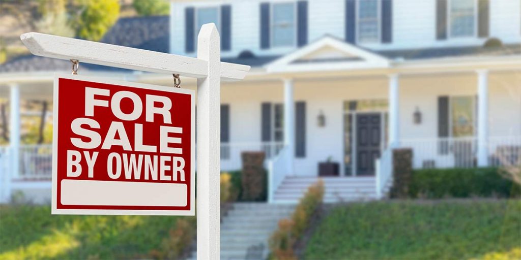 A how with a for sale by owner real estate sign